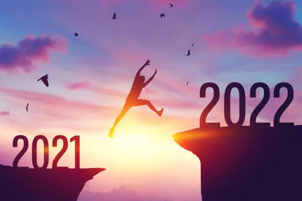 silhouette man jumping between cliff with number 2021 to 2022 and picture id1325918582